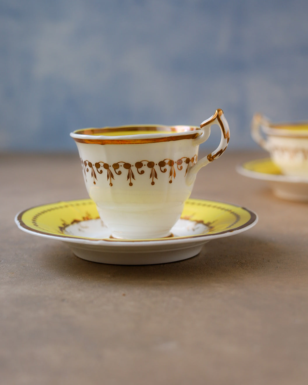 Coppia di trio in porcellana Minton, fondo giallo e oro dipinto a mano, Inghilterra, primi dell’800
